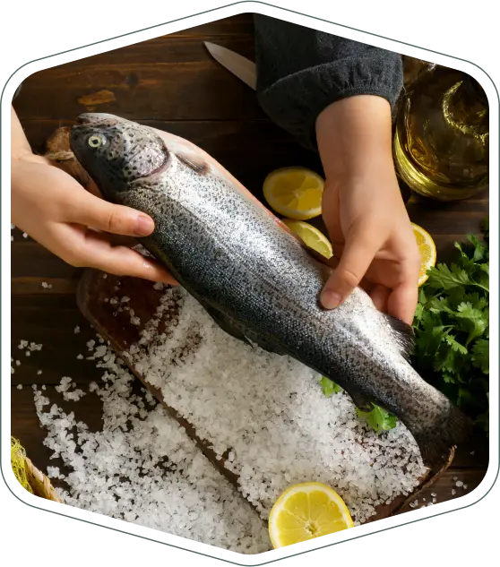 hands holding whole fresh fish